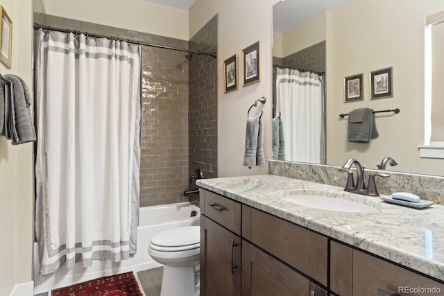 bathroom with vanity, toilet, and shower / tub combo