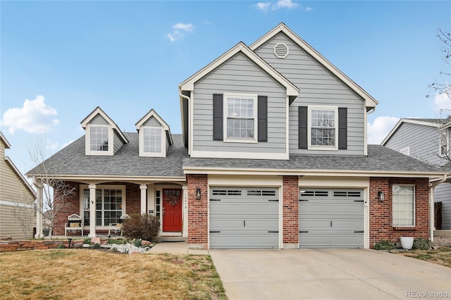 traditional home with brick siding, concrete driveway, and a garage