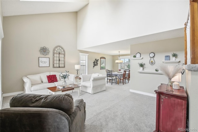 living area with baseboards, a towering ceiling, and carpet
