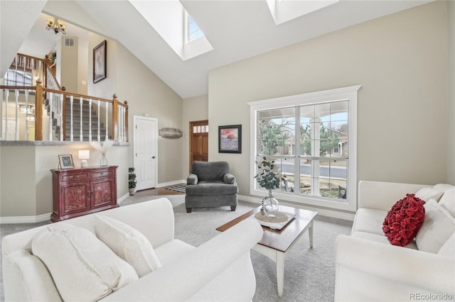 living room featuring baseboards, high vaulted ceiling, visible vents, and a skylight