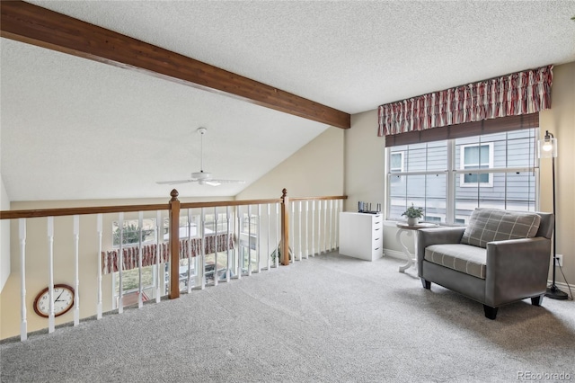 sitting room with carpet floors, vaulted ceiling with beams, and plenty of natural light