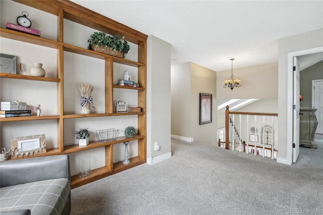 sitting room featuring carpet floors, a notable chandelier, baseboards, and an upstairs landing