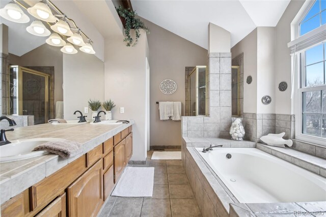 full bath featuring lofted ceiling, a shower stall, a sink, double vanity, and a bath
