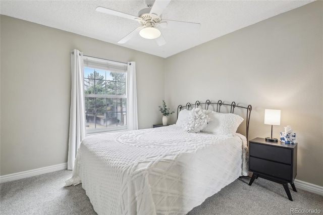 bedroom featuring baseboards, ceiling fan, carpet flooring, and a textured ceiling