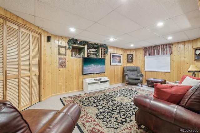 living room featuring recessed lighting, wooden walls, and carpet flooring