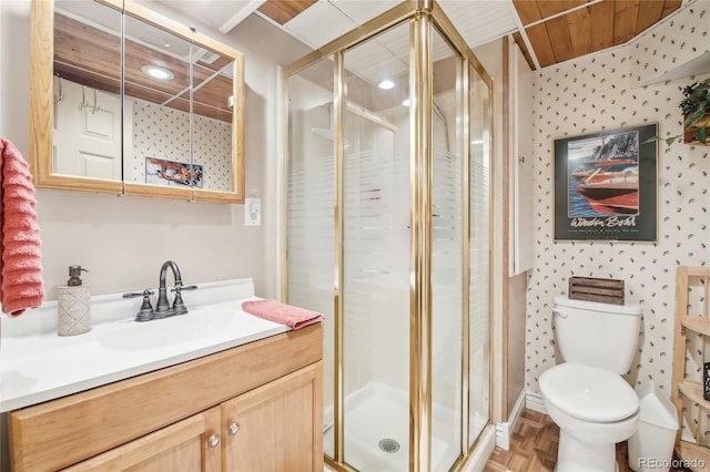 bathroom with wallpapered walls, vanity, toilet, and a shower stall