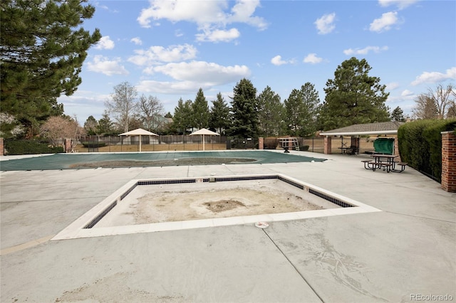 pool featuring fence, a gazebo, and a patio area