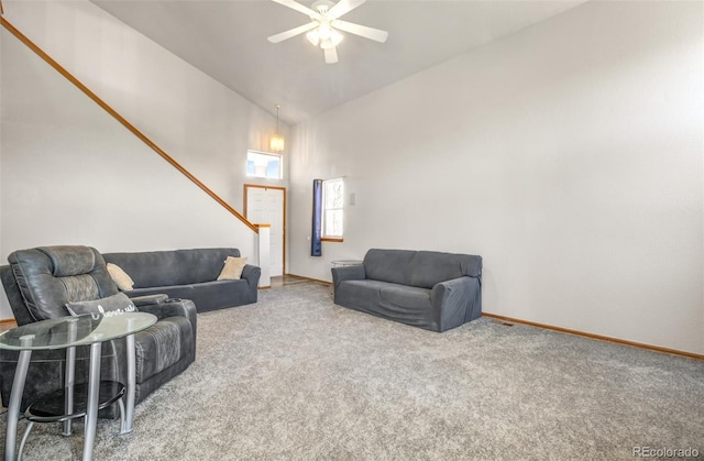 living area featuring high vaulted ceiling, carpet, a ceiling fan, and baseboards