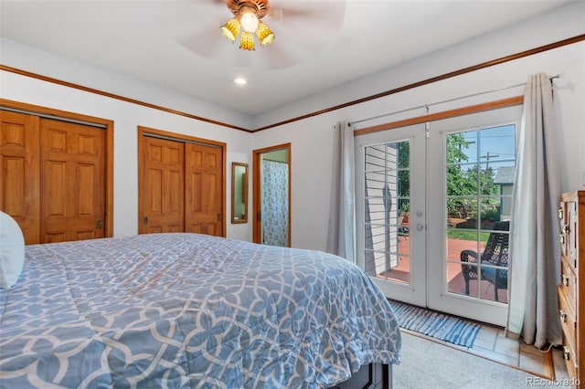 bedroom featuring ceiling fan, access to outside, french doors, and multiple closets