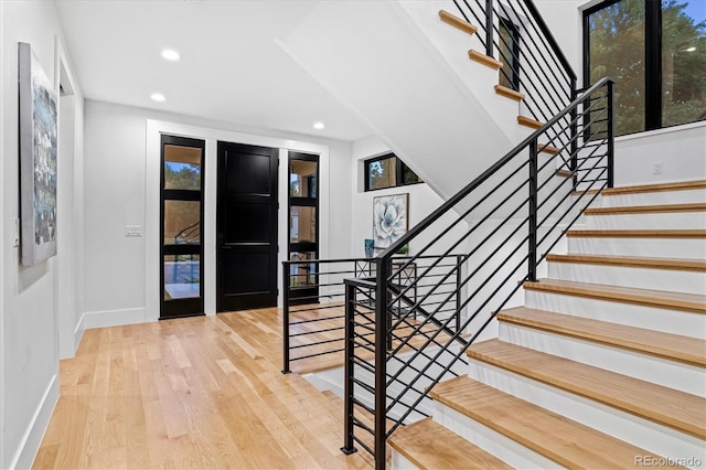 foyer featuring a wealth of natural light, recessed lighting, wood finished floors, and baseboards
