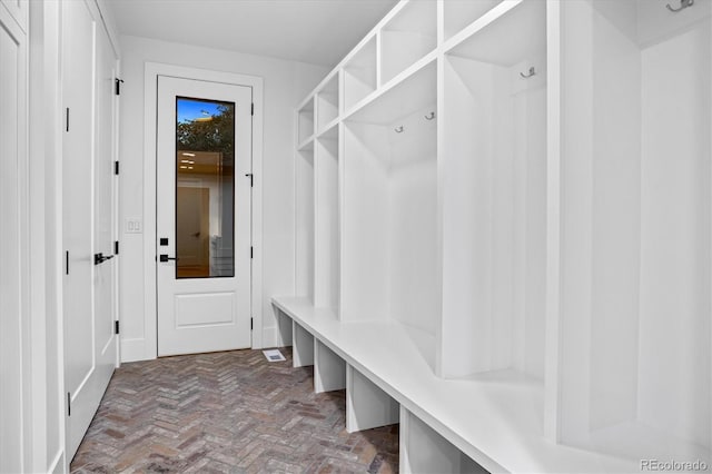 mudroom featuring brick floor