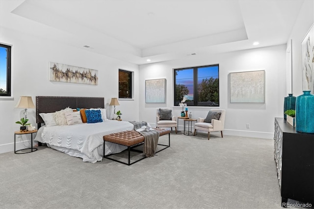 carpeted bedroom featuring recessed lighting, visible vents, a tray ceiling, and baseboards