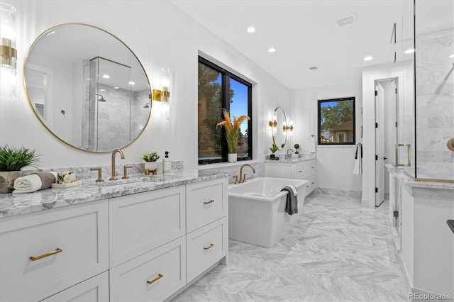 bathroom featuring two vanities, a sink, and recessed lighting