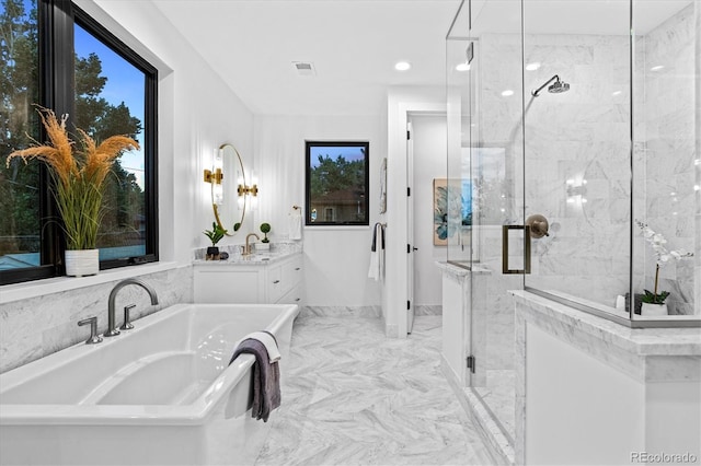 bathroom with a freestanding tub, vanity, visible vents, marble finish floor, and a marble finish shower