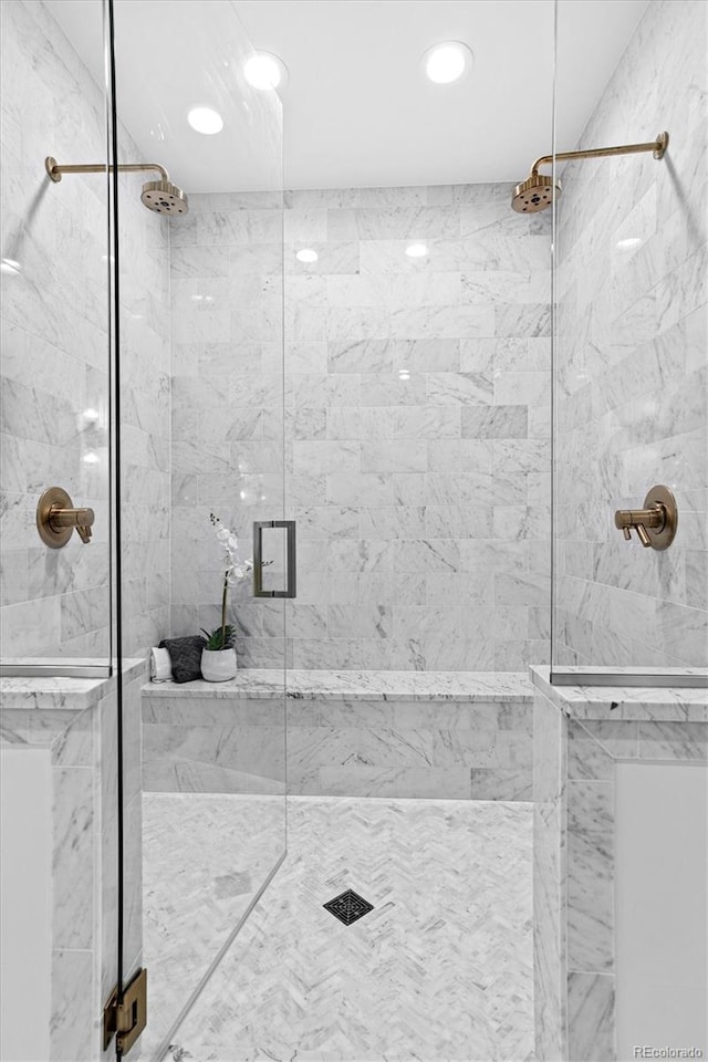 full bath featuring recessed lighting and a marble finish shower