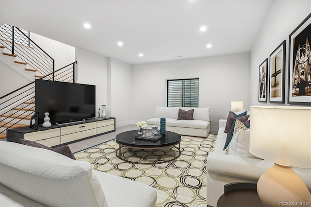 living room with baseboards, stairway, and recessed lighting