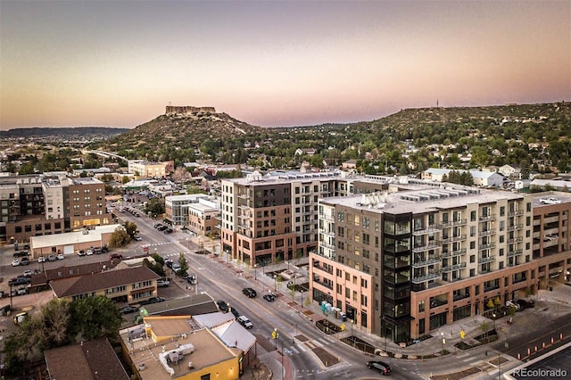 aerial view at dusk with a mountain view and a view of city