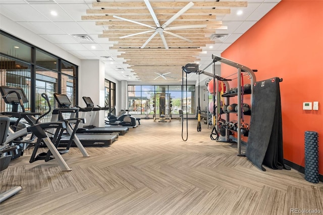 gym featuring carpet floors, visible vents, and expansive windows