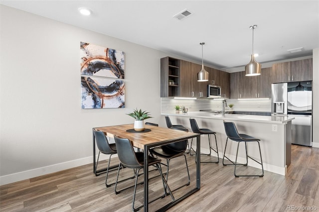 dining room with visible vents, baseboards, recessed lighting, and light wood-style floors