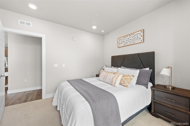 bedroom with light wood-style floors, baseboards, visible vents, and recessed lighting