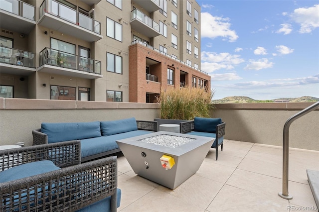 view of patio featuring an outdoor living space with a fire pit