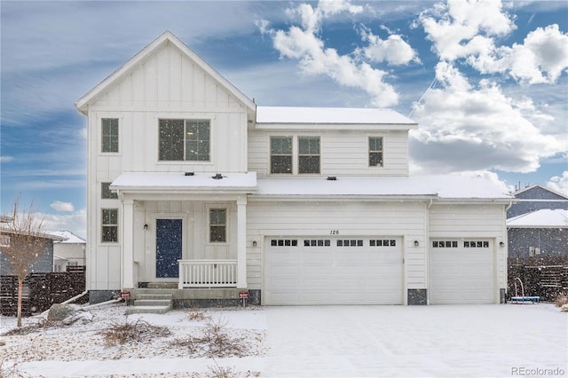 view of front facade with driveway, a garage, and board and batten siding