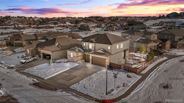 aerial view at dusk featuring a residential view