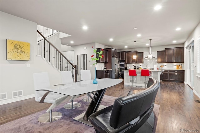 dining area featuring dark wood finished floors, recessed lighting, and visible vents