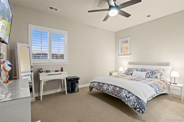 carpeted bedroom featuring visible vents, ceiling fan, and baseboards