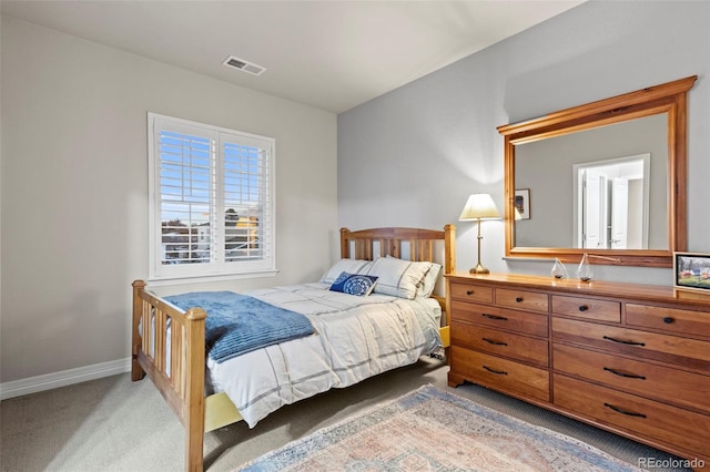 bedroom featuring baseboards, visible vents, and light carpet