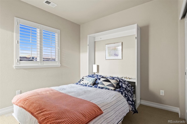 bedroom with visible vents, baseboards, and carpet flooring