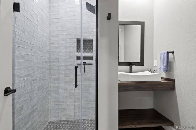 full bathroom featuring a stall shower and a textured wall