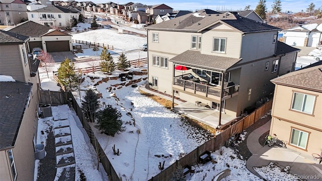 snowy aerial view featuring a residential view