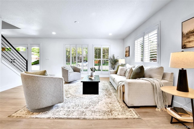 6716 W Rowland Ave, Littleton, CO 80128 - living area with light wood finished floors, recessed lighting, and stairs