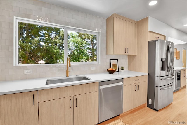 6716 W Rowland Ave, Littleton, CO 80128 - kitchen featuring stainless steel appliances, light brown cabinetry, a sink, wine cooler, and light countertops