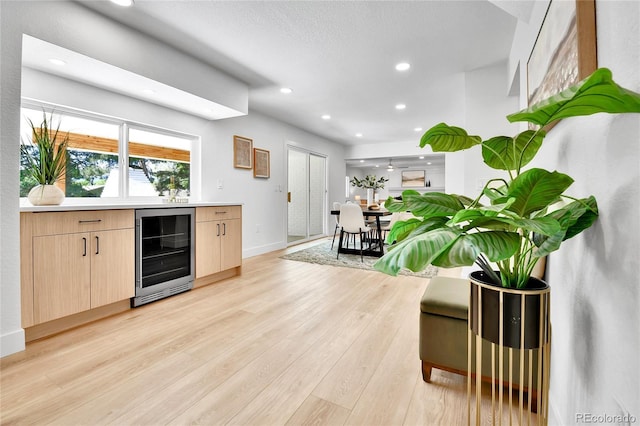 6716 W Rowland Ave, Littleton, CO 80128 - bar area with wine cooler, light wood-style flooring, recessed lighting, and baseboards
