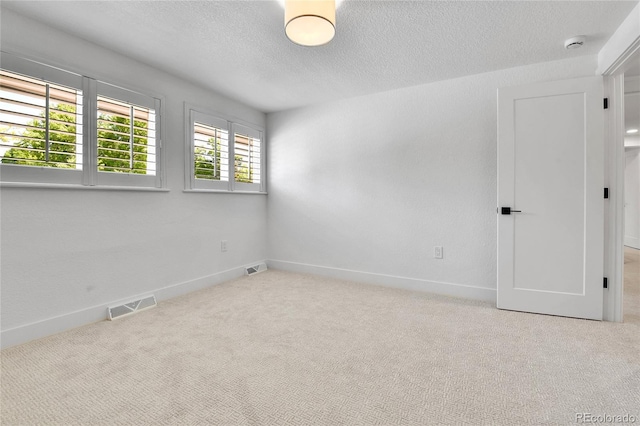 6716 W Rowland Ave, Littleton, CO 80128 - empty room with carpet, a textured ceiling, baseboards, and a smoke detector