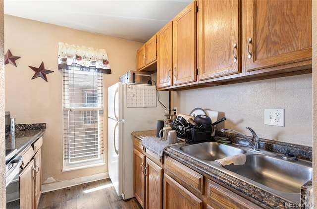 4310 Loomis Ave, Colorado Springs, CO 80906 - kitchen with stainless steel electric range, dark wood-style flooring, freestanding refrigerator, a sink, and dark countertops