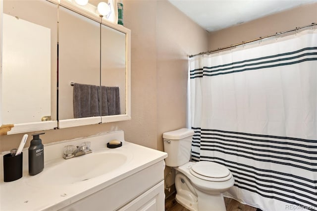 4310 Loomis Ave, Colorado Springs, CO 80906 - bathroom featuring vanity, curtained shower, toilet, and wood finished floors