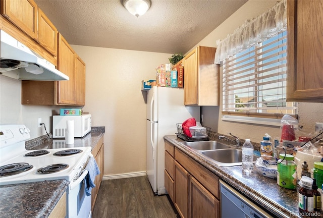 4310 Loomis Ave, Colorado Springs, CO 80906 - kitchen with white appliances, dark wood-style floors, a sink, under cabinet range hood, and dark countertops