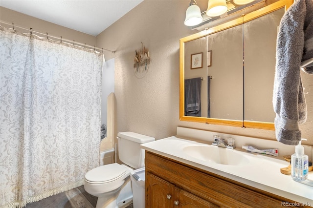 4310 Loomis Ave, Colorado Springs, CO 80906 - bathroom featuring vanity, toilet, a textured wall, and shower / tub combo with curtain