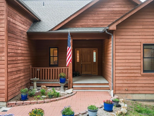 28465 Cragmont Dr, Evergreen, CO 80439 - property entrance featuring a porch and a shingled roof