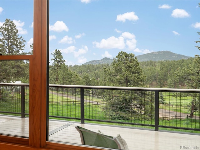 28465 Cragmont Dr, Evergreen, CO 80439 - wooden deck featuring a mountain view and a wooded view