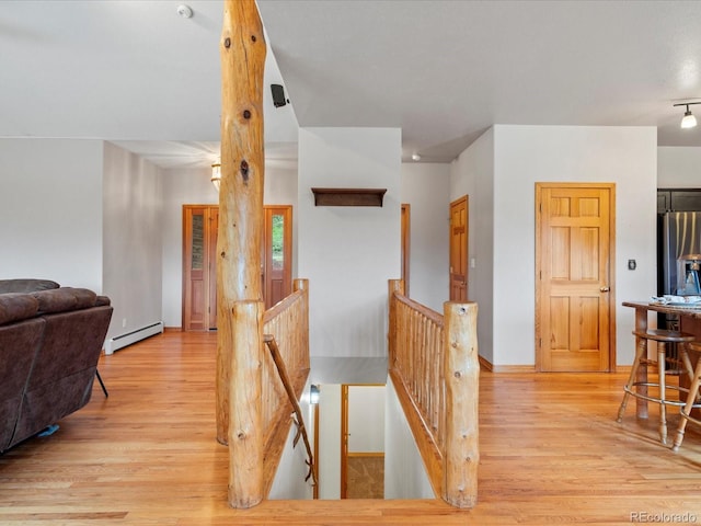 28465 Cragmont Dr, Evergreen, CO 80439 - hall featuring baseboard heating, an upstairs landing, and light wood finished floors