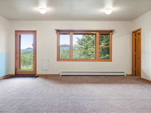 28465 Cragmont Dr, Evergreen, CO 80439 - empty room featuring a baseboard heating unit and carpet flooring