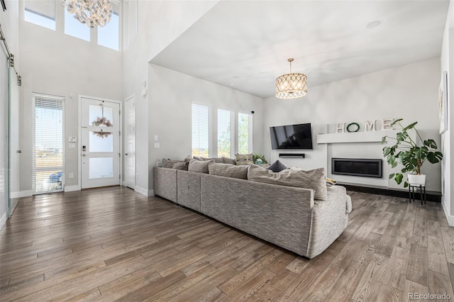 living room with hardwood / wood-style floors and a notable chandelier