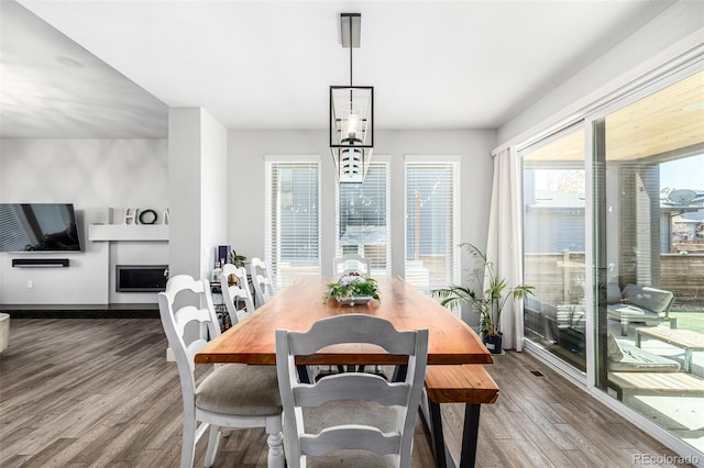 dining space with a notable chandelier and hardwood / wood-style flooring