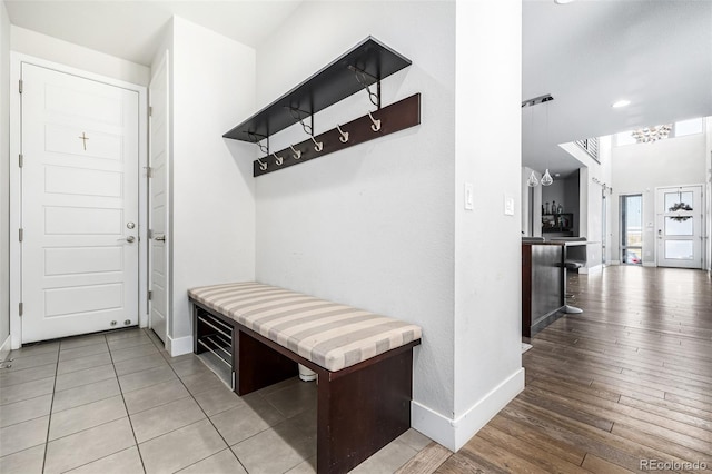 mudroom featuring hardwood / wood-style flooring and a chandelier