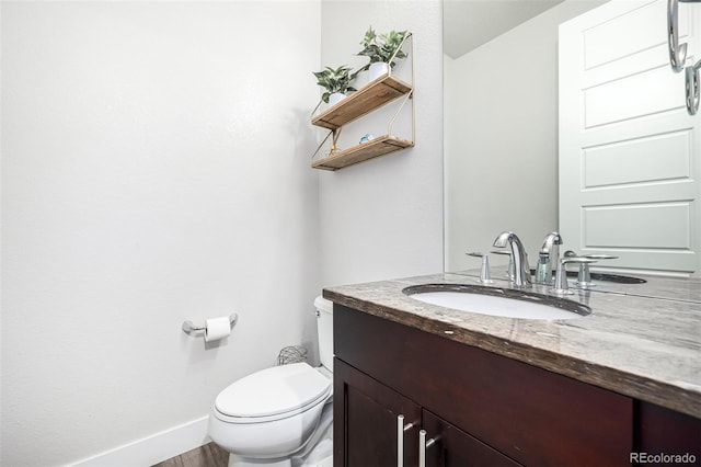 bathroom featuring toilet and vanity