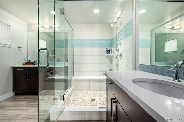 bathroom with walk in shower and vanity